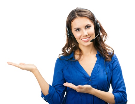 Portrait of happy smiling cheerful young support phone operator in headset showing copyspace area or something, isolated over white backgroundの写真素材