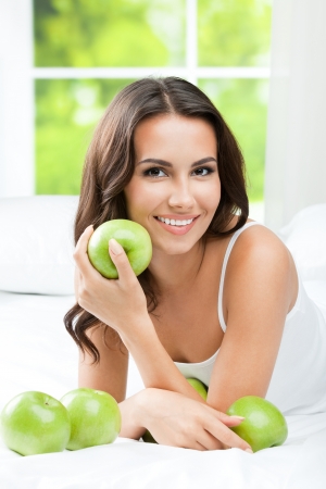 Young happy smiling woman with applesの写真素材