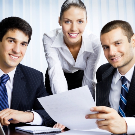 Three businesspeople working with document at office の写真素材