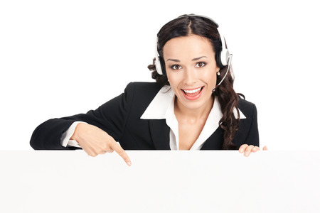 Happy smiling young customer support phone operator in headset showing blank signboard, isolated over white backgroundの写真素材