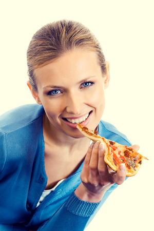 Beautiful young woman eating pizzaの写真素材