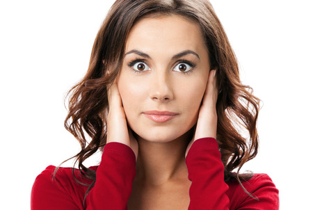 Portrait of young brunette woman covering with hands her ears, isolated on white backgroundの写真素材