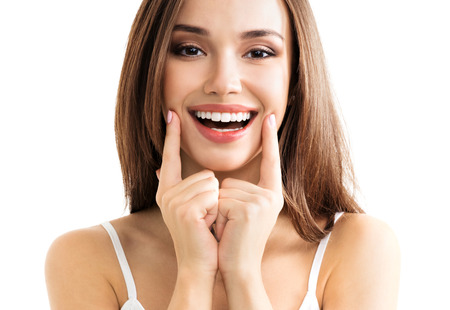 Young woman showing smile, in casual smart clothing, isolated against white background. Caucasian brunette model in emoshions and optimistic, positive, happy feeling concept studio shoot.