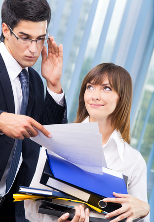 Two businesspeople working with documents at office. Teamwork, partnership, cooperation and business success concept.の写真素材