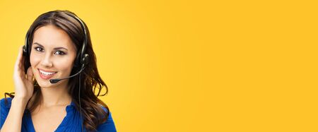 Call center service. Customer support phone sales operator with copy space area for some text or slogan, over yellow orange color background. Banner composition.の写真素材