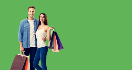 Love, holiday sales, shop, retail, consumer concept - happy couple with shopping bags, standing...