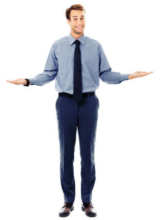 Comparison concept - confident businessman showing, holding or giving something on both flat hands for similar choice, isolated against white background. Copyspace for some text. Full body portraitの写真素材