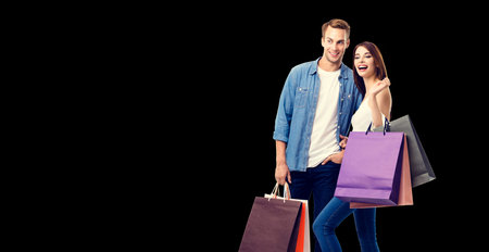 Love, holiday sales, shop, retail, consumer concept - happy excited laughing couple with shopping...