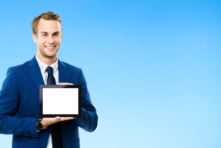 Portrait of businessman showing blank tablet pc, with copy space area for some text, advertising or...