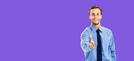 Businessman giving hand for handshake, over violet purple color background. Success in business,...
