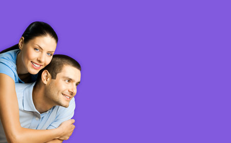 Portrait image of embracing happy smiling couple in blue casual clothing, love studio concept,...