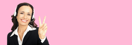 Call center service. Customer support phone sales operator in headset showing two fingers or victory...