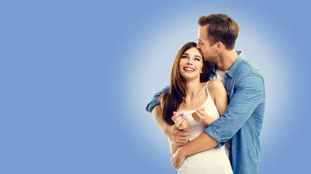 Love, new parents and family concept - very happy excited couple, finding out results of a pregnancy test. Blue color background. Man and woman at studio shot image.の写真素材