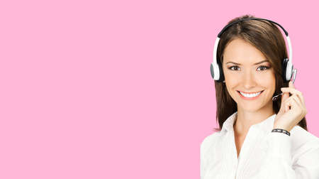 Call Center Service. Face portrait image of customer support or answer worker, sales agent. Caller, receptionist phone female operator. Helpline answering and telemarketing. Rose pink background.の写真素材