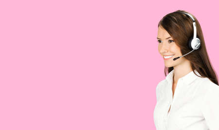 Call Center Service. Profile face portrait image of customer support or answer worker, sales agent. Caller, receptionist phone female operator. Helpline answering and telemarketing. Pink color backの写真素材