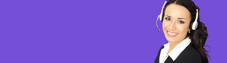 Call center service. Customer support or sales operator in headset, isolated over violet purple color background with copy space area for slogan text, imaginary, product. Female phone answering workerの写真素材