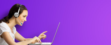Call center. Profile side studio image of customer support advertiser sale operator in headset. Pointing businesswoman or phone worker with laptop computer. Answering service agent, on violet purple.の写真素材