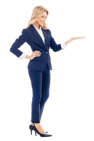 Full body of smiling businesswoman in confident blue suit, showing, giving or holding some product or copy space for text, isolated over white background.の写真素材