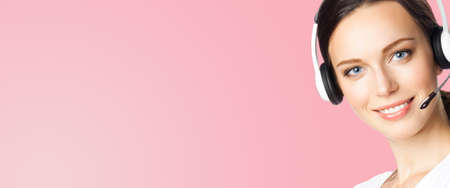 Call center help line service. Face portrait image of customer support phone sales operator in headset, over rose pink. Brunette business woman. Adviser.の写真素材