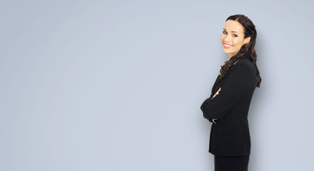 Happy smiling attractive businesswoman, with copy space area for some slogan or advertising text....