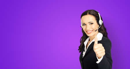 Call center service. Customer support phone sales operator in headset showing thumb up hand sign gesture, violet purple background with copy space area for text.の写真素材