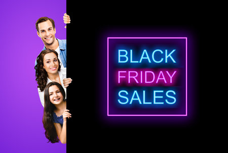 Family portrait image - smiling father, mother and little daughter peek out from behind big board, isolated on violet purple background. Paper broadsheet with black friday sales text signの写真素材