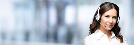 Call Center Service. Female customer support or sales agent. Confident caller or receptionist phone operator. Helping, answering, consulting. Blurred office background.の写真素材