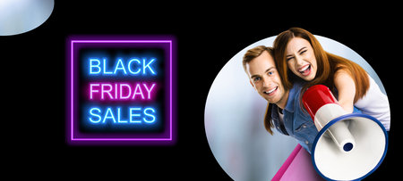 Portrait of happy excited couple with megaphone and shopping bags. Man and woman shout saying in loudspeaker mega phone. Big deals, discounts offers concept. Black Friday sales neon light sign.の写真素材