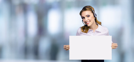 Call Center Service. Customer support or sales agent. Businesswoman or caller or receptionist phone operator showing empty signboard with copy space text area, at office. Help, answering, consulting.の写真素材