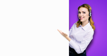 Call Center Service. Customer support or sales agent. Businesswoman or caller or receptionist phone operator showing banner with copy space. Helping, answering, consulting. Violet purple background.の写真素材