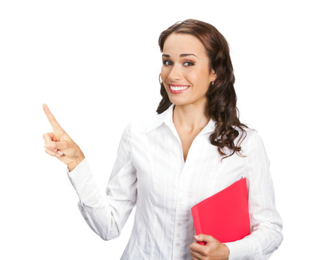 Portrait image of smiling business woman with red folder showing, pointing, advertising something or copyspace area, isolated white background. Businesswoman, office worker, teacher, real estate agentの写真素材