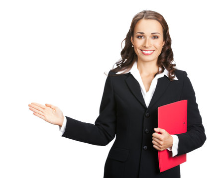 Portrait image of happy smiling business woman in black confident suit showing, advertising, isolated white background. Executive office worker, teacher or real estate agent with red folderの写真素材