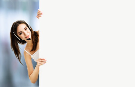 Call Center Service. Customer support or sale agent. Caller or female receptionist phone operator showing empty banner with copy space, indoor. Help, answering, consulting.の写真素材