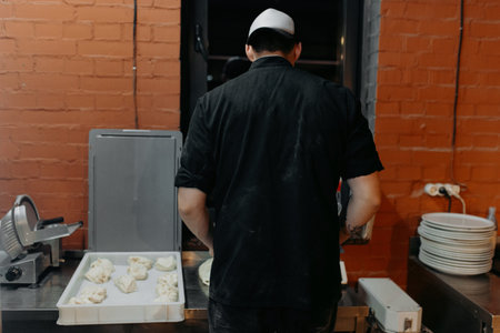 A chef is putting a handmake fresh pizza in a wood burning brick oven pizza.