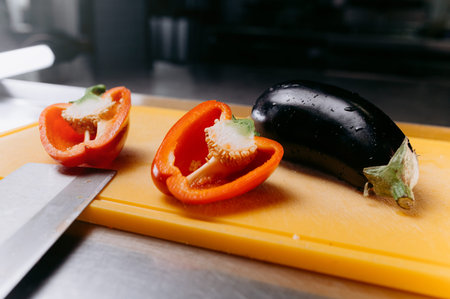 cutting fresh red pepper into strips. cutting vegetables