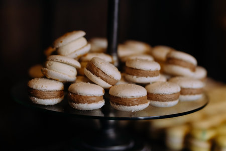 Macaroons Cakes with cream on a plate. Table with sweets, dessert.の写真素材