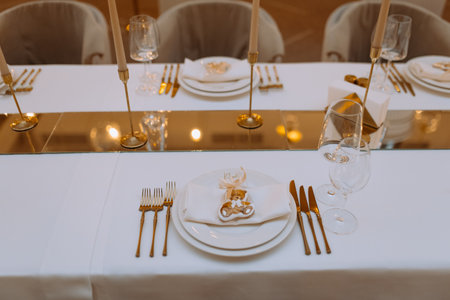 wedding luxury table setting crystal wine glass and gold forks and knives. Catering banquet. table decor for celebration anniversary, christmas, new year. table settin gresaurant. selective focusの写真素材