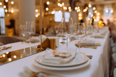 wedding luxury table setting crystal wine glass and gold forks and knives. Catering banquet. table decor for celebration anniversary, christmas, new year. table settin gresaurant. selective focusの写真素材