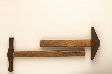 Old rusty hammers on a white wooden background. Horizontal. top view Copyspace.の写真素材