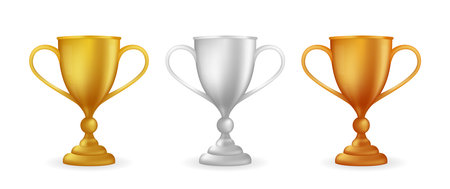 Realistic award winner cups. Golden, silver and bronze trophy set. Vector illustrationのイラスト素材