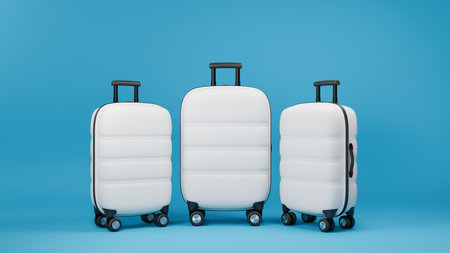 Three white traveling suitcases on blue background. Large and small cases with luggage. 3D rendering.の写真素材