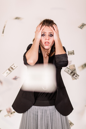 she was crying and flying around money. White background, Studio lightの写真素材