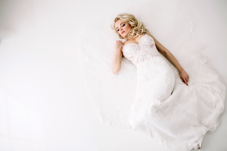 Fashionable and modern bride, beautiful blonde girl, smiling with happiness and loveの写真素材