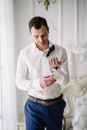 male portrait in butterfly and white shirtの写真素材
