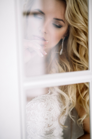 Fashionable and modern bride, beautiful blonde girl, smiling with happiness and loveの写真素材