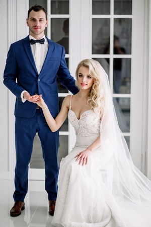 Bride and groom at the wedding Day. Wedding couple, happy newlywed woman and man, in a beautiful hotel room, studio. Loving couple. Bride and groomの写真素材
