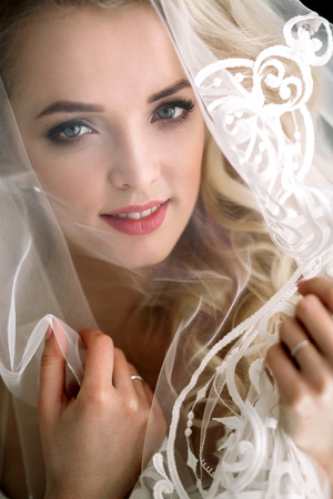 Fashionable and modern bride, beautiful blonde girl, smiling with happiness and loveの写真素材