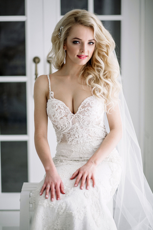 Fashionable and modern bride, beautiful blonde girl, smiling with happiness and loveの写真素材