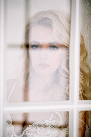 Fashionable and modern bride, beautiful blonde girl, smiling with happiness and loveの写真素材