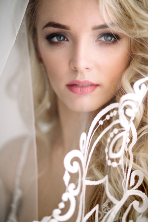 Fashionable and modern bride, beautiful blonde girl, smiling with happiness and loveの写真素材